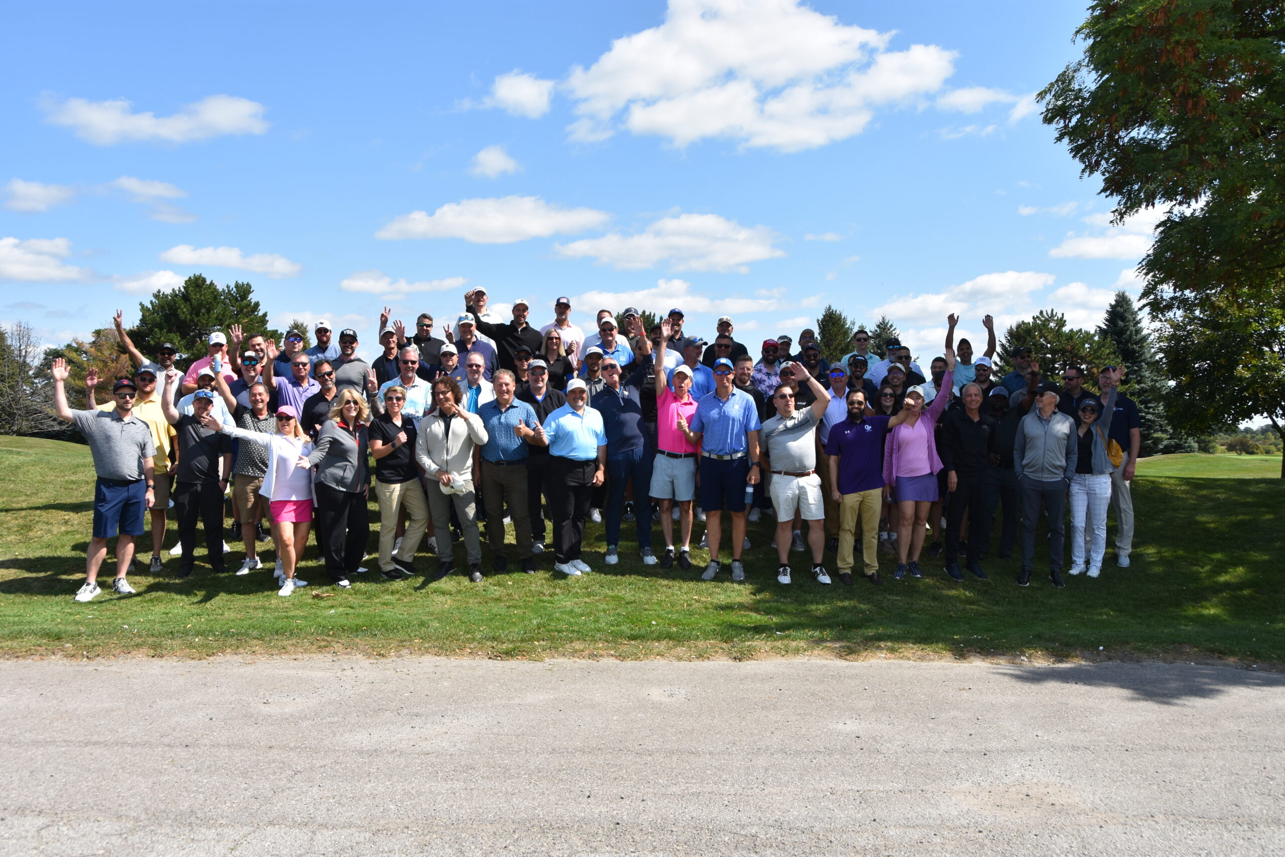 Group of Golfers on a golf course posing for a photo